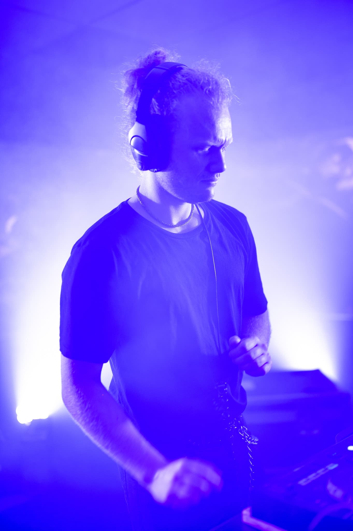Nomadic DJing at a Wellington club under blue stage light